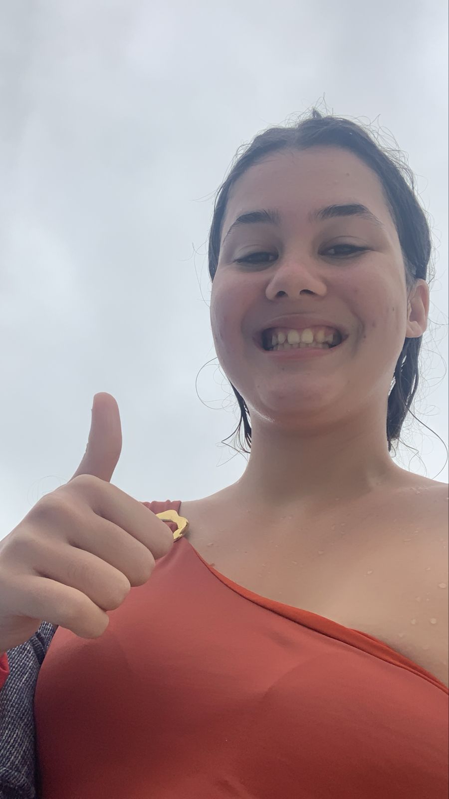 Ester na praia fazendo joinha